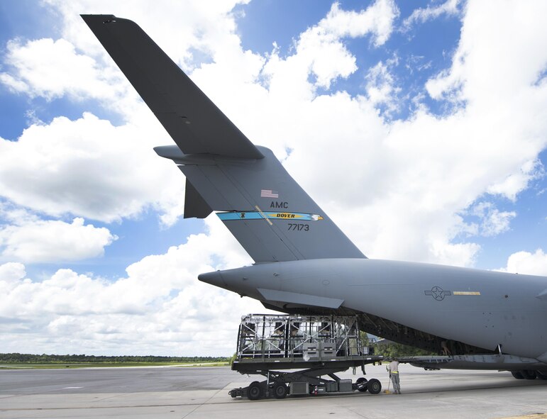 A Transportation Isolation System (TIS) is loaded onto a C-17 Globemaster III aircraft during Exercise Mobilty Solace at Joint Base Charleston, S.C., Aug. 15, 2016. Mobility Solace provides Air Mobility Command, working with joint partners, the opportunity to evaluate the protocols and operational sequences of moving multiple patients exposed or infected with Ebola using the TIS, while also minimizing the risks to aircrew, medical attendants and the airframe. The TIS is a modular, scalable system, composed of at least one isolation pallet for patient transportation and care, one pallet configured as an "antechamber" to provide medical members with an enclosed space to safely decontaminate and remove their personal protective equipment before exiting. (U.S. Air Force Photo/Airman Megan Munoz)
