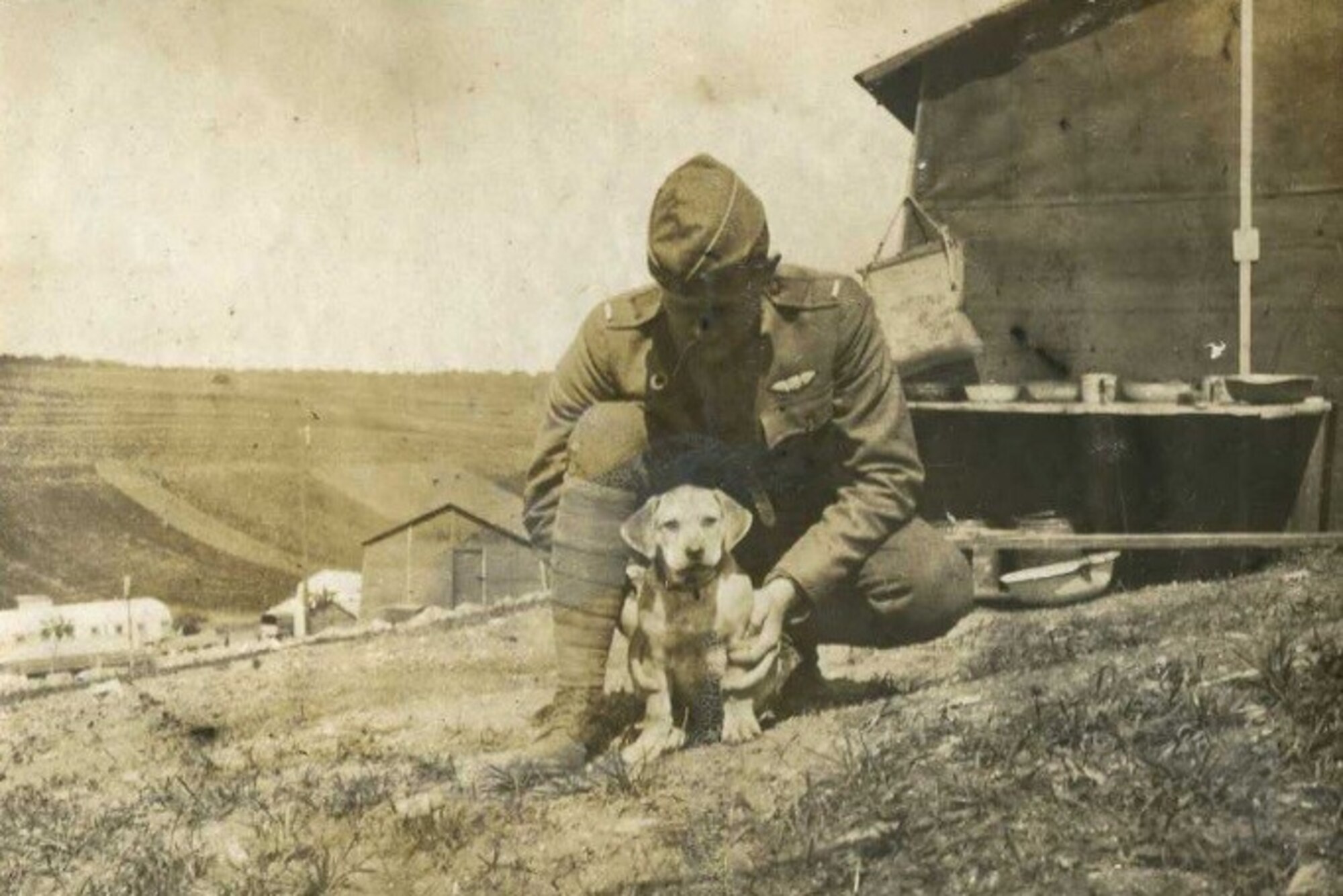 U.S. Army Air Corps 1st Lt. John Fairall kneels with the first mascot of the 88th Aero Squadron, Wrinkles. The 88th AS would eventually go on to become the 436th Training Squadron, celebrating 99 years of service Aug. 17, 2016.  (U.S. Air Force courtesy photo)