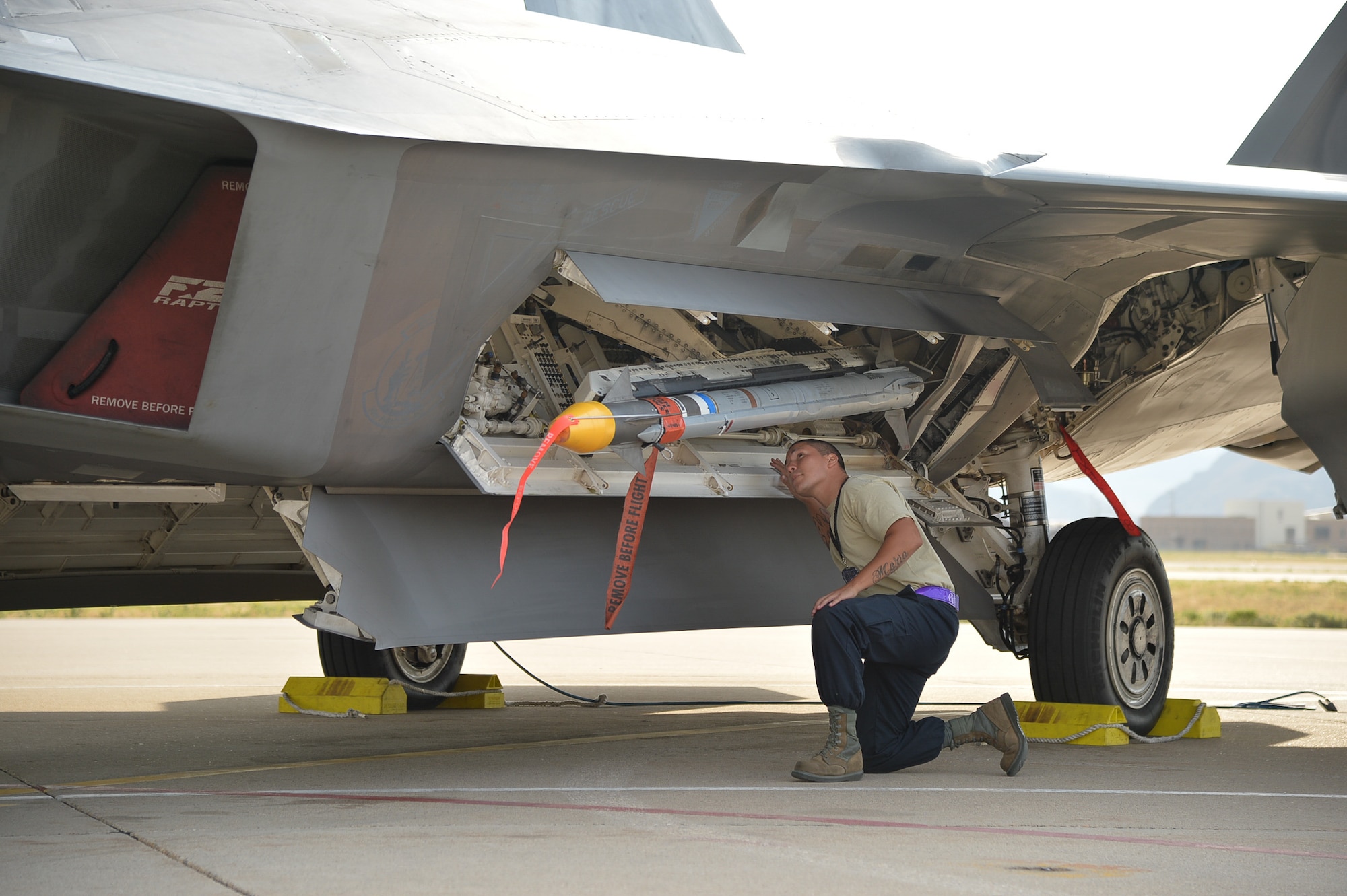 Staff Sgt. Anthony Ovechka, 95th Aircraft Maintenance Unit weapons load team chief, Tyndall Air Force Base, Fla., inspects an AIM-9X missile installation on an F-22 Raptor aircraft prior to launch during the Combat Archer exercise at Hill Air Force Base, Utah, Aug. 18, 2016. (U.S. Air Force photo by R. Nial Bradshaw)