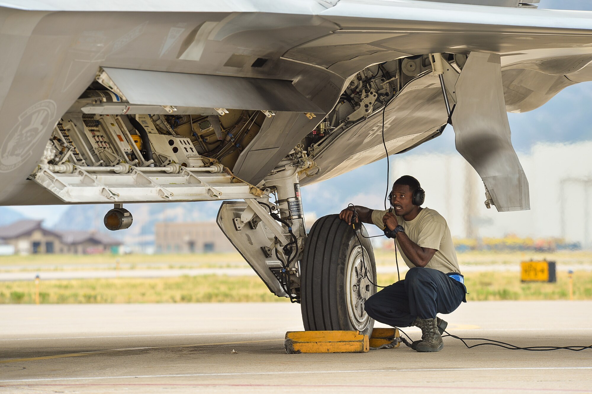 Senior Airman Isaiah Williams, a crew chief assigned to 95th Aircraft Maintenance Unit, Tyndall Air Force Base, Fla., performs final checks before launching an F-22 Raptor aircraft during exercise Combat Archer at Hill Air Force Base, Utah, Aug. 18, 2016. (U.S. Air Force photo by R. Nial Bradshaw)