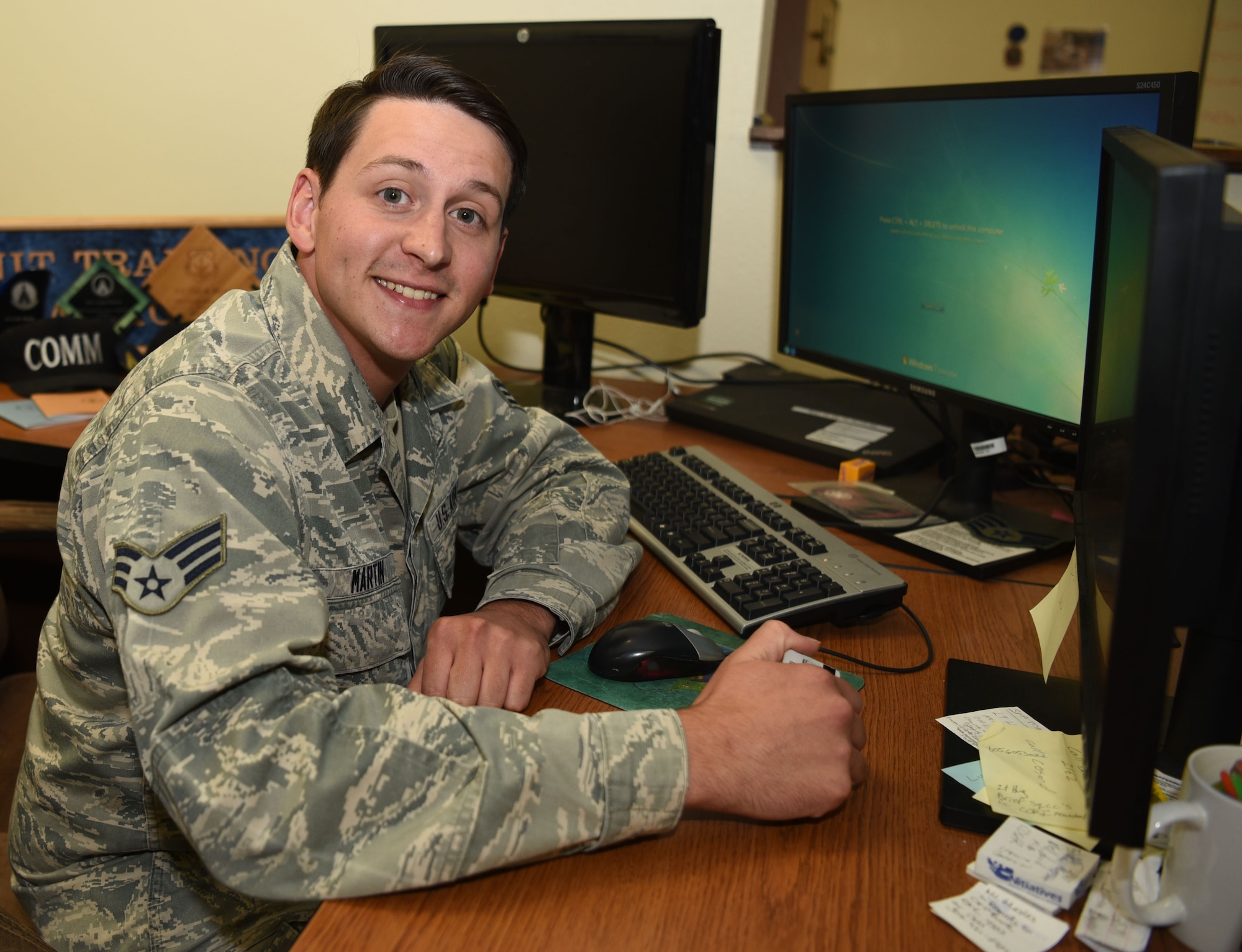 Senior Airman Cody Martin, 90th Communications Squadron cybersecurity technician, sits at his desk at F.E. Warren Air Force Base, Wyo., August 16, 2016. The squadron manages the base computer network and email accounts. (U.S. Air Force photo by Airman 1st Class Breanna Carter)