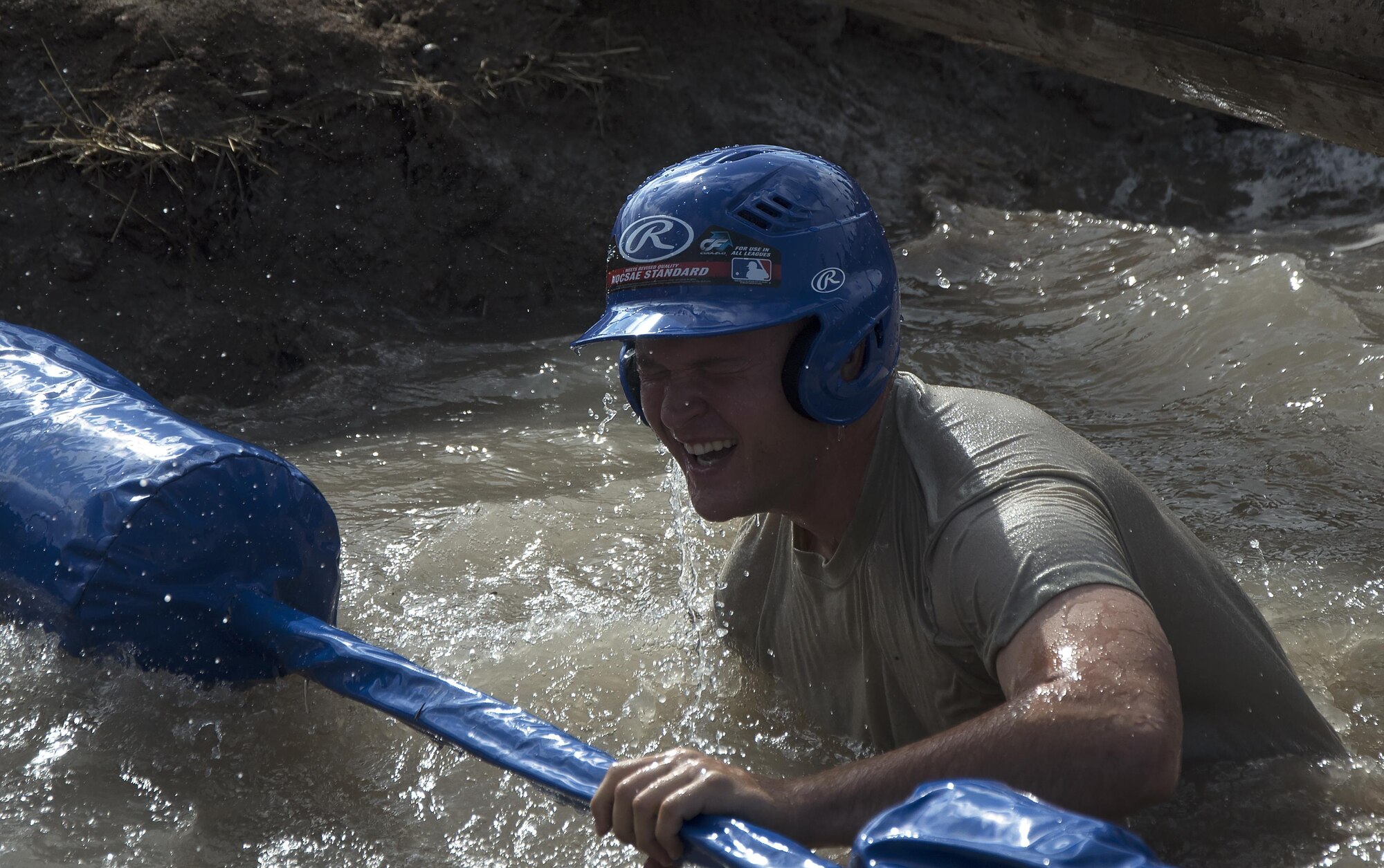 Charles Bower, 790th Missile Security Forces Squadron Tactical Response Force member, emerges from a water pit during the annual Frontiercade jousting competition at F.E. Warren Air Force Base, Wyo., Aug. 19, 2016. Contestants had to balance on a log while trying to knock off their opponent with a pugil stick. (U.S. Air Force photo by Senior Airman Brandon Valle)