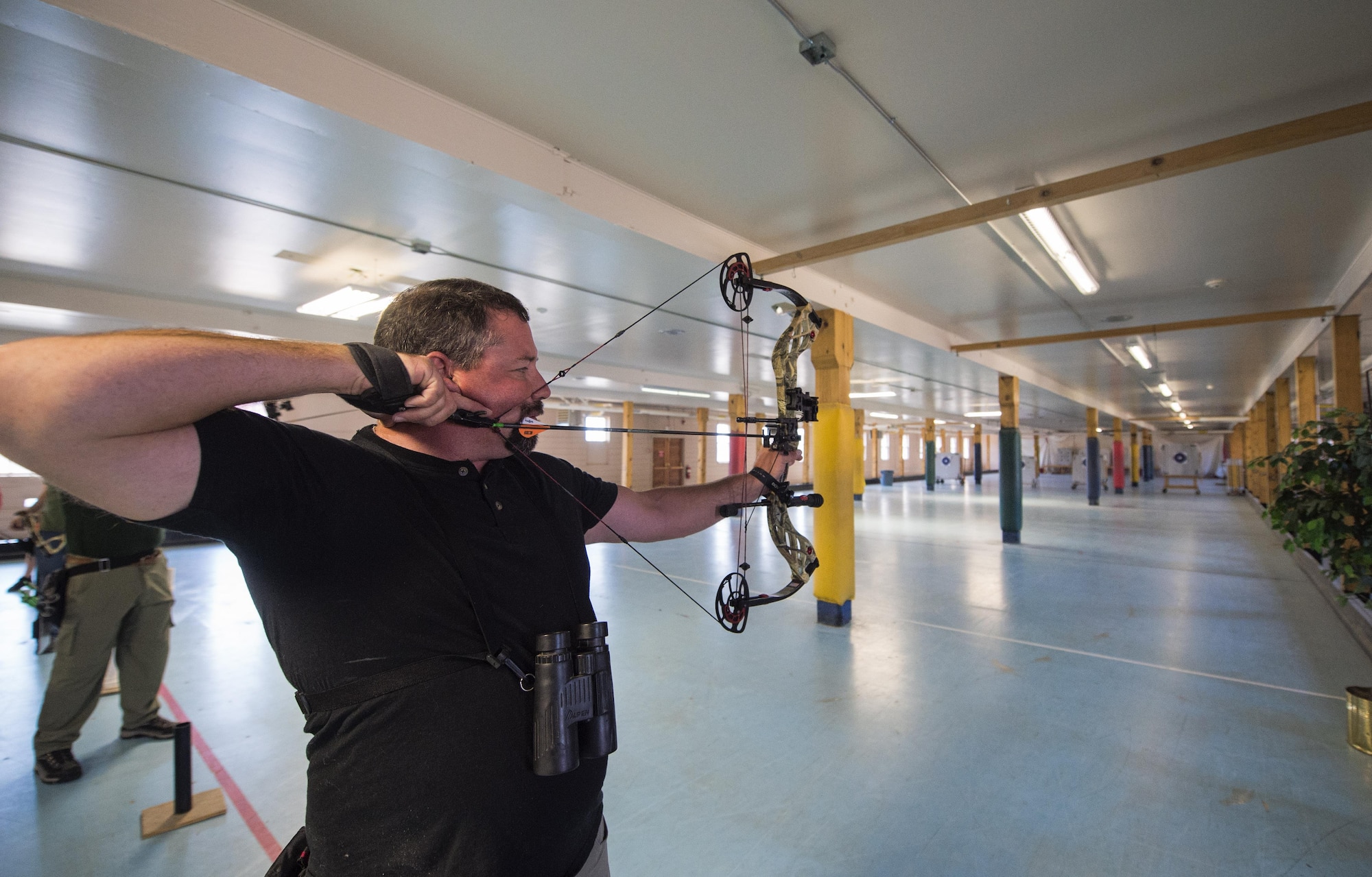 Bobby Johnson, 90th Civil Engineer Squadron environmental engineer, aims an arrow at his target during the annual Frontiercade archery competition at F.E. Warren Air Force Base, Wyo., Aug. 19, 2016. The event was comprised of more than five, two-person teams from units on base. (U.S. Air Force photo by Staff Sgt. Christopher Ruano)