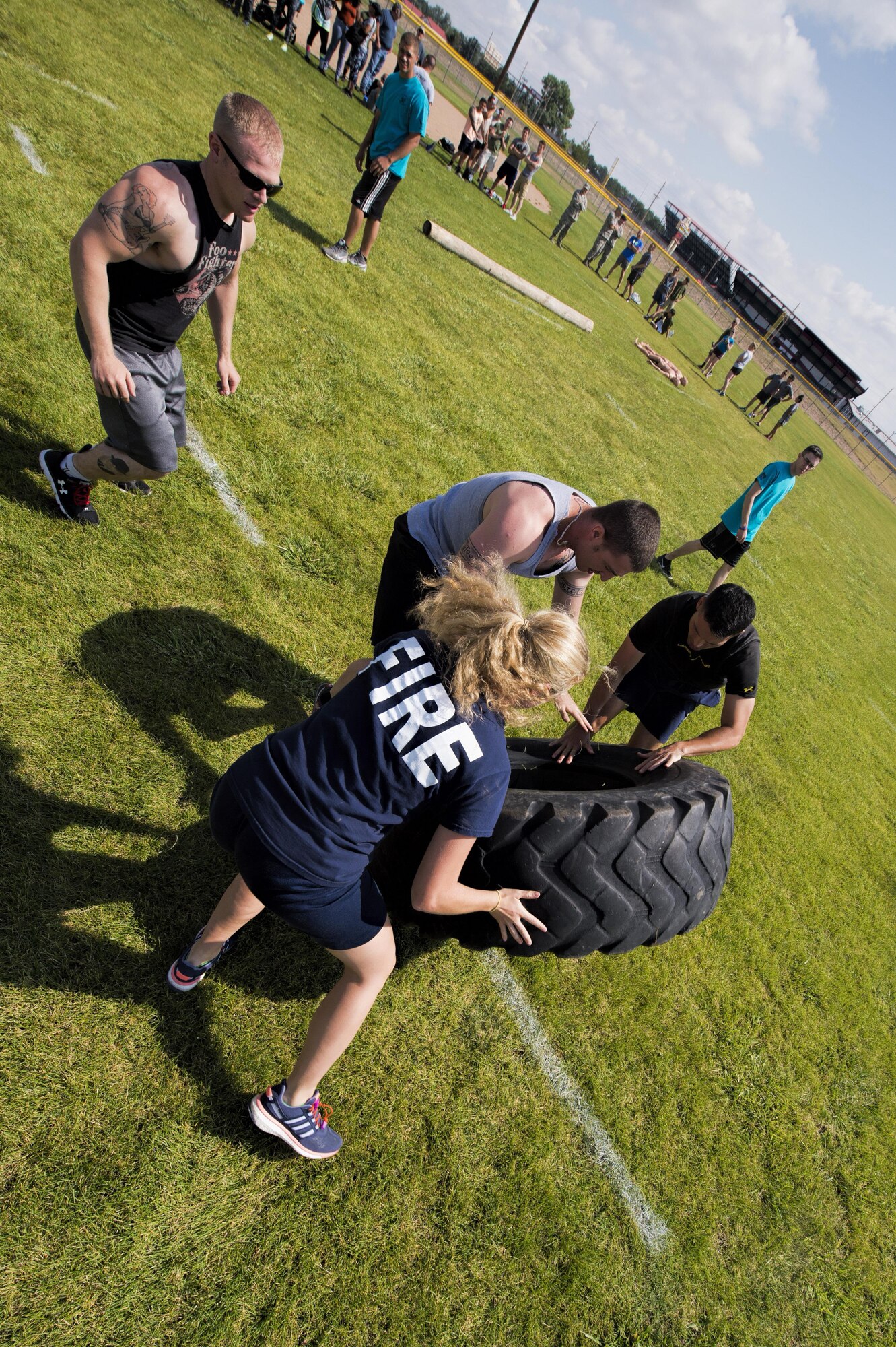 The 90th Civil Engineer Squadron team flips a tire during the annual Frontiercade team-endurance competition at F.E. Warren Air Force Base, Wyo., Aug. 19, 2016. Frontiercade is an event held yearly on base to promote friendly competition amongst the units of 90th Missile Wing. (U.S. Air Force photo by Staff Sgt. Christopher Ruano)