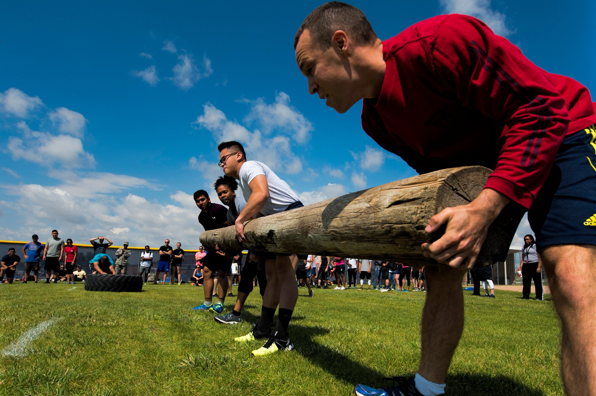 The 90th Medical Group team lifts a log during the annual Frontiercade team-endurance competition at F.E. Warren Air Force Base, Wyo., Aug. 19, 2016. The event required teams to lift a tire for a set distance, carry a log and run a timed relay race. (U.S. Air Force photo by Staff Sgt. Christopher Ruano)