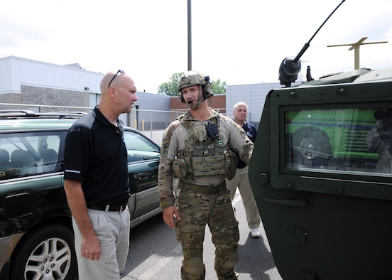 An Airmen with the 274th Air Support Operations Squadron (ASOS) is briefing local employers on the equipment that they utilize, as part of a Boss Day event hosted by the Employer Support of the Guard and Reserve (ESGR) on Hancock Field, Thursday, August 18. ESGR is a Department of Defense program established in 1972 to encourage cooperation between Reserve Component Service members and their employers. ESGR events like the Boss Day allow employers to see what their employees take part in as part of their military commitment. (U.S. Air National Guard photo by Tech. Sgt. Jeremy M. Call/Released)