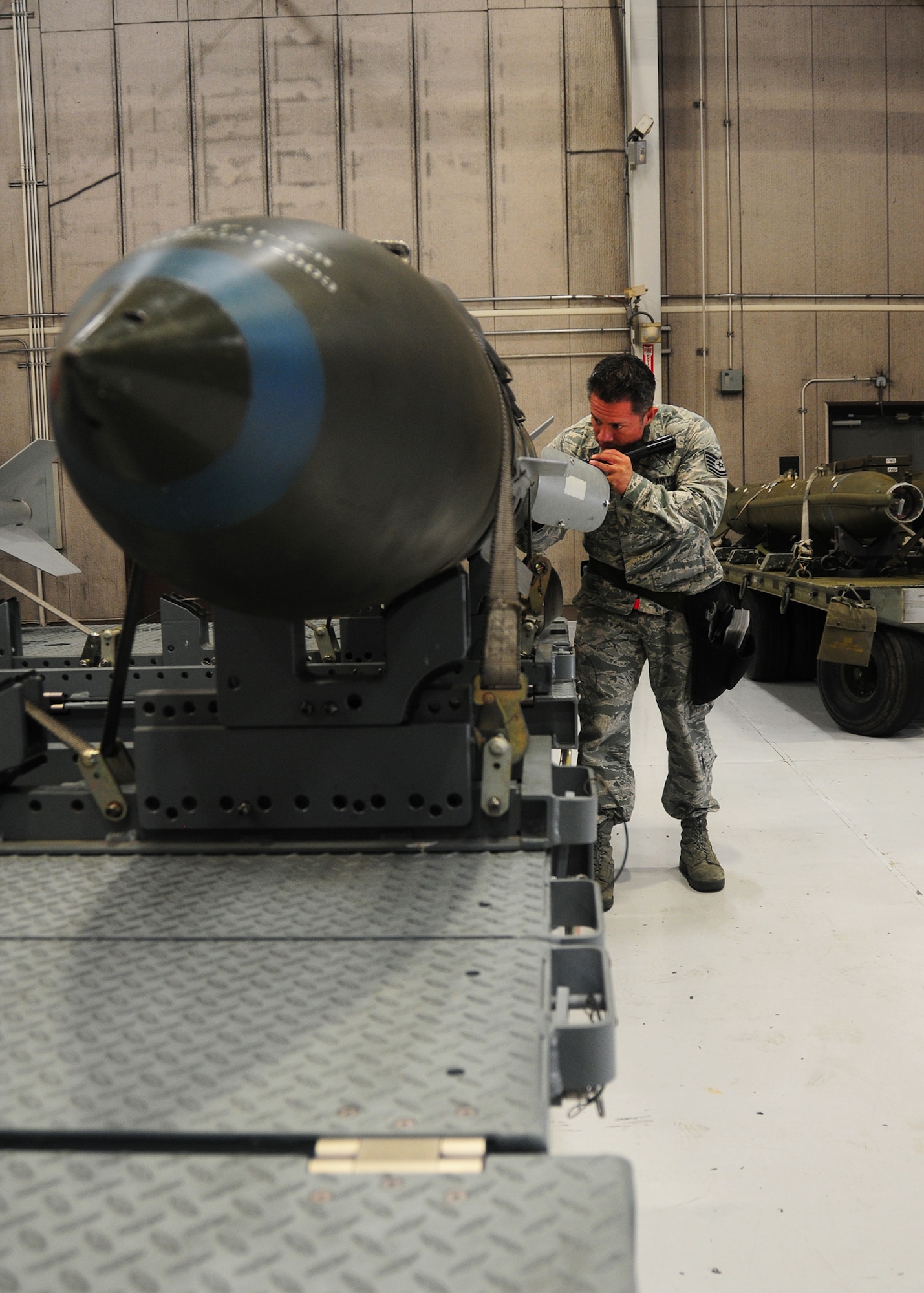 Tech. Sgt. Ricardo Zuniga, 131st Aircraft Maintenance Squadron weapons load team chief, inspects a V3 Joint Direct Attack Munition before a practice load on the weapons load trainer at Whiteman Air Force Base, Missouri. Zuniga, who had to relearn to walk after a motorcycle accident in 2006, has worked on the B-2 Spirit since his recovery after the accident and was part of the 131st Bomb Wing's Nuclear Surety Inspection in August 2013. (U.S. Air National Guard photo by Senior Airman Nathan Dampf) 