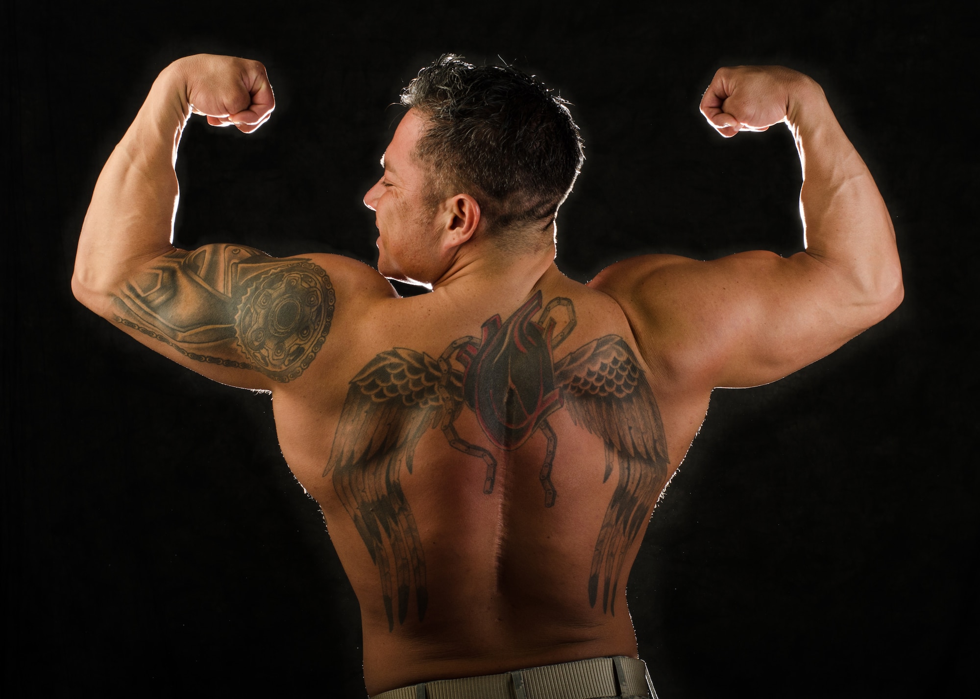 Tech. Sgt. Ricardo Zuniga, weapons load team chief with the 131st Aircraft Maintenance Squadron, won the first Whiteman Classic bodybuilding event in Sedalia, Missouri, in Nov. 2015. Zuniga’s tattoo partially covers the scar from multiple back surgeries after a motorcycle accident forced him to relearn to walk and take better care of his physical condition. (U.S. Air National Guard photo by Airman 1st Class Halley Burgess)