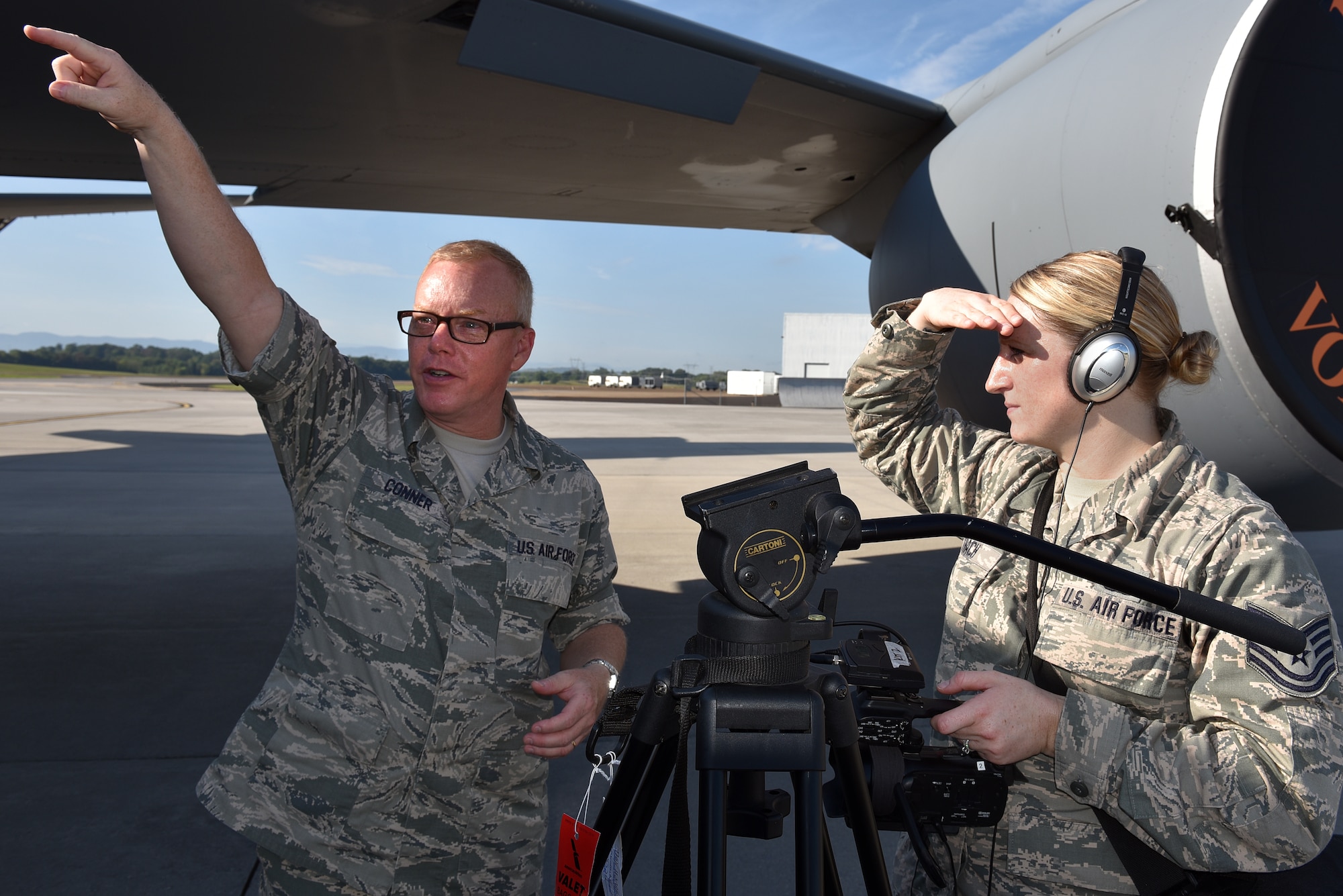 Master Sgt. Bill Conner, instructor, talks about camera shots during the Smoky Short Course in broadcasting with Tech. Sgt. Mary Thach, photojournalist assigned to the Nebraska Air National Guard, August 17, 2016, on the flight line at McGhee Tyson Air National Guard Base in Louisville, Tenn. (U.S. Air National Guard photo by Master Sgt. Mike R. Smith) 