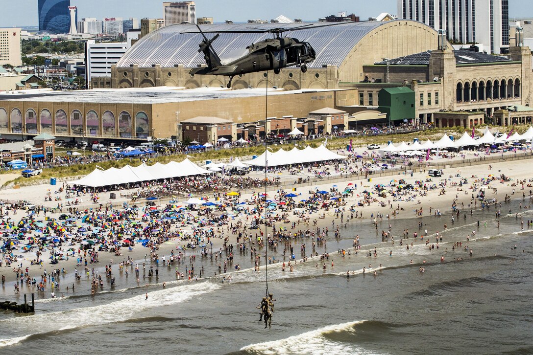 A UH-60 Black Hawk helicopter and airmen demonstrate insertion and extraction techniques at the 2016 Atlantic City Airshow over the boardwalk in Atlantic City, N.J., Aug. 17, 2016. The airmen are assigned to the New Jersey Air National Guard's 227th Air Support Operations Squadron and the Black Hawk is assigned to the New Jersey Army National Guard's 1st Battalion, 150th Assault Helicopter Regiment. Air National Guard photo by Master Sgt. Mark C. Olsen