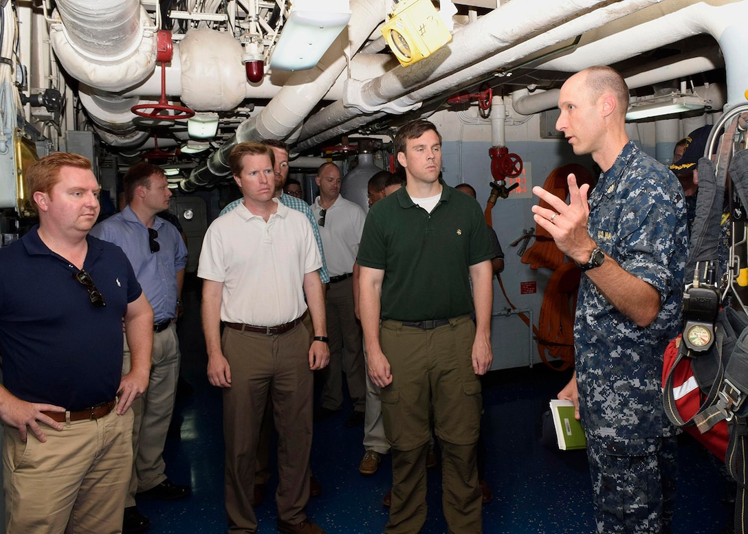 POLARIS POINT, Guam (Aug. 16, 2016) Lt. Bradley Newsad, the Command Judge Advocate and Public Affairs Officer aboard the submarine tender USS Emory S. Land (AS 39), describes a repair locker and its uses to personnel staff from the House Armed Services Committee during a tour of the Emory S. Land. Emory S. Land, homeported in Guam, conducts maintenance on surface ships and submarines in the U.S. 5th and 7th Fleet areas of operations. (U.S. Navy photo by Mass Communication Specialist Seaman Daniel S. Willoughby)
