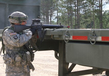 FORT MCCOY, WIs. -- Cpl. Robert Achterberg, a water treatment specialist from the 651st Quartermaster Company out of Evansville, Wyo., returns fire on enemy roleplayers during a base assault as part of the Combat Support Training Exercise here in Fort McCoy, Wis., on Aug. 16, 2016. CSTX immerses Army Reserve Soldiers and other service members in real-world  training scenarios to enhance unit readiness in the planning, preparation, and execution of combat service support operations. (U.S. Army Reserve photo by Spc. Christopher A. Hernandez, 345th Public Affairs Detachment)