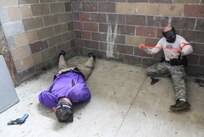 MUSCATATUCK URBAN TRAINING CENTER (MUTC) - An officer of the Indiana State Police applies a tourniquet during a training exercise at Muscatatuck Urban Training Center on Aug. 16, 2016. The training is conducted to prepare the officers for situations that may occur in a real world scenario.
(U.S. Army Reserve photo by, Spc. Eddie Serra, 205th Press Camp Headquarters)