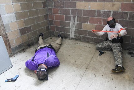 MUSCATATUCK URBAN TRAINING CENTER (MUTC) - An officer of the Indiana State Police applies a tourniquet during a training exercise at Muscatatuck Urban Training Center on Aug. 16, 2016. The training is conducted to prepare the officers for situations that may occur in a real world scenario.
(U.S. Army Reserve photo by, Spc. Eddie Serra, 205th Press Camp Headquarters)