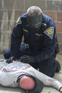 MUSCATATUCK URBAN TRAINING CENTER (MUTC) - An officer of the Indiana State Police detains another officer during a "solo officer response to active shooter" exercise at Muscatatuck Urban Training Center on Aug. 16, 2016. The officers took turns cautiously moving through the building to engage and detain the threat.
(U.S. Army Reserve photo by, Spc. Eddie Serra, 205th Press Camp Headquarters)