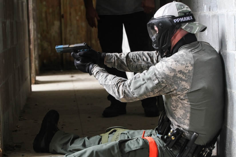 MUSCATATUCK URBAN TRAINING CENTER (MUTC) - An Indiana State Police officer holds his position and applies his tourniquet to a simulated injury after neutralizing the threat during training at Muscatatuck Urban Training Center on Aug. 16, 2016. The purpose of the exercise was to test officers' situational awareness and decision-making while under pressure so they will be able to react to a situation if one occurs. (U.S. Army Reserve photo by Spc. Eddie Serra, 205th Press Camp Headquarters)