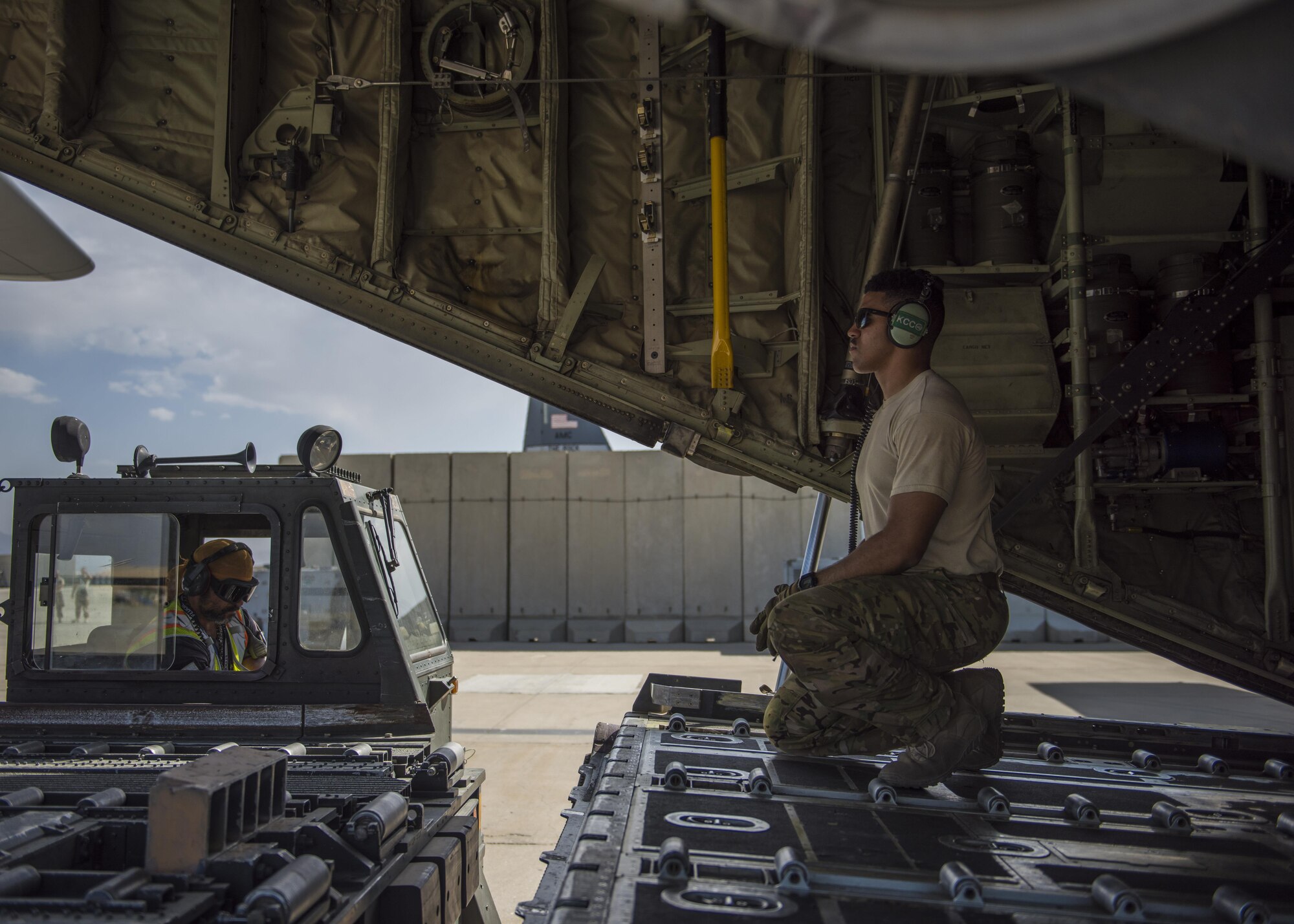 Staff Sgt. Dallion Richards, 774th Expeditionary Airlift Squadron loadmaster, directs a 60k runner aircraft cargo loader, Bagram Airfield, Afghanistan, Aug. 19, 2016. Aircraft loadmasters are responsible for properly loading, securing and escorting cargo and passengers, and ensuring the plane is properly balanced with the weight of the cargo evenly distributed. (U.S. Air Force photo by Senior Airman Justyn M. Freeman)
