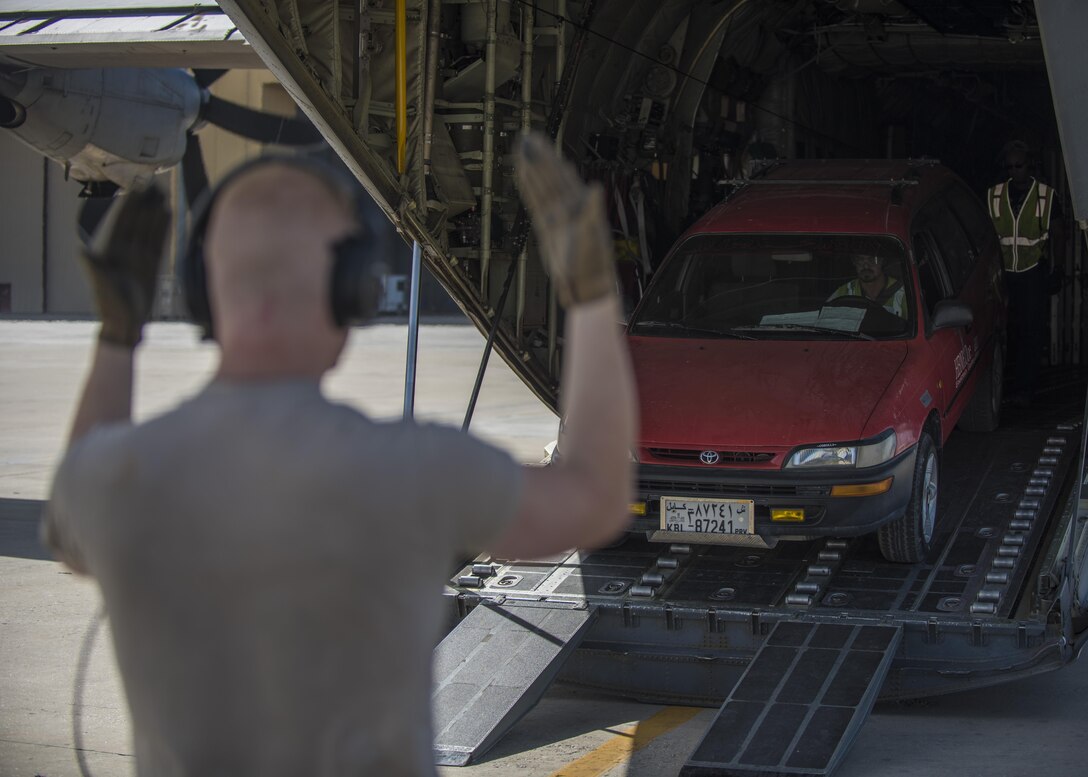 Senior Airman Andrew Garrett, 774th Expeditionary Airlift Squadron loadmaster, directs a vehicle out of a C-130J Super Hercules, Bagram Airfield, Afghanistan, Aug. 19, 2016. As a loadmaster, Garrett ensures that cargo and personnel are properly loaded. (U.S. Air Force photo by Senior Airman Justyn M. Freeman)