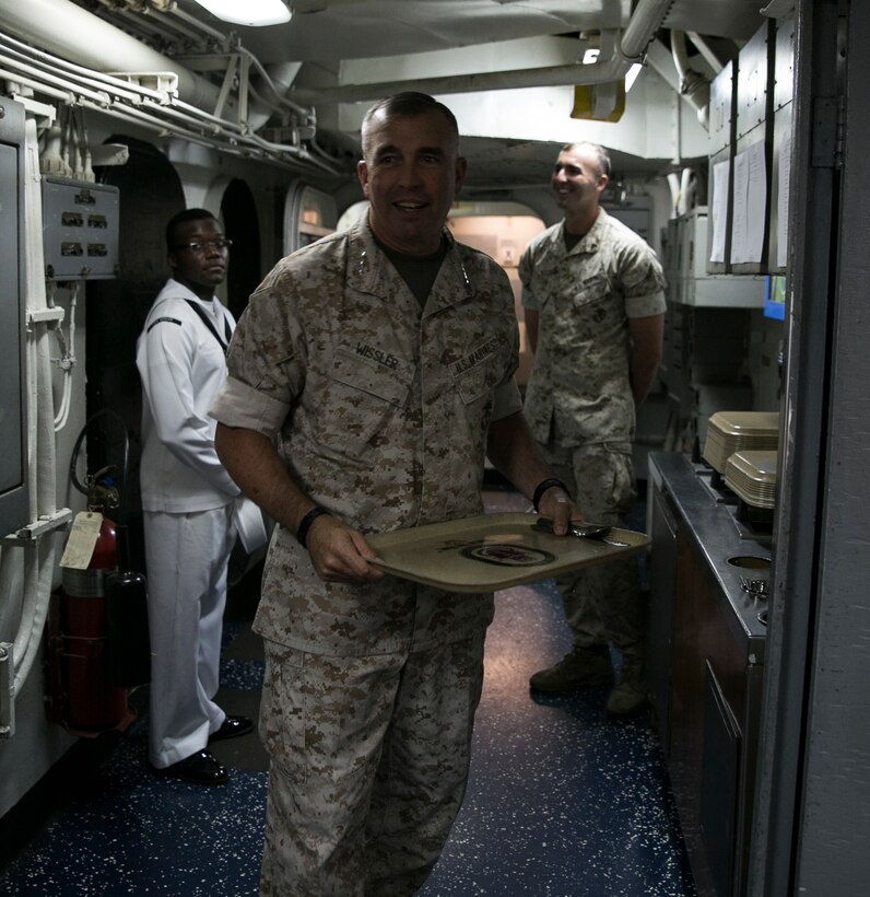 Commander, U.S. Marine Corps Forces Command, Lt. Gen. John E. Wissler, prepares to eat lunch with Marines participating in exercise Bold Alligator 2016 in the galley of the amphibious assault ship USS Bataan (LHD 5) Aug 17, 2016. BA16 focuses on improving Navy-Marine Corps amphibious core competencies along with coalition, North Atlantic Treaty Organization, Allied and partner nations as an investment in the current and future readiness of naval forces.