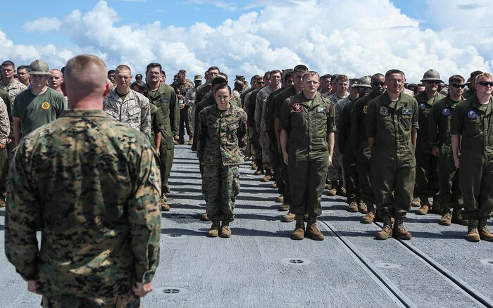 U.S. Marine Corps Sgt. Maj. Dylan W. Goldman, Sergeant Major, Headquarters Regiment, 2nd Marine Logistics Group, calls Marines and Sailors with 2nd Marine Logistics Group and 2nd Marine Air Wing to attention during exercise Bold Alligator 16 aboard the SS Wright (T-AVB 3) in the Atlantic Ocean, Aug. 16, 2016. Bold Alligator is a joint service exercise held annually in order to ensure service members are capable of sustaining themselves while at sea.