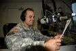 U.S. Army Reserve Soldier Sgt. Zechariah Gerhard with the 345th Public Affairs Detachment reads the national news during a radio show at Muscatatuck Urban Training Center, Butlerville, Ind., Aug. 20, 2016. (U.S. Army Reserve photo by Maj. Jennifer Mack/Released)