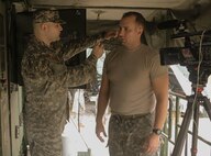 FORT HOOD, Texas – Spc. Logan Rath, an Army Reserve public affairs broadcaster, prepares to interview Spc. Jarod Neven on Aug. 16, 2016, about the laundry advance system used for operations by the 340th Quartermaster Company. (U.S. Army Reserve photo by Sgt. Michael Adetula/Released)