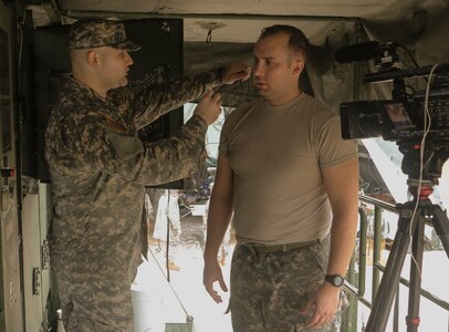 FORT HOOD, Texas – Spc. Logan Rath, an Army Reserve public affairs broadcaster, prepares to interview Spc. Jarod Neven on Aug. 16, 2016, about the laundry advance system used for operations by the 340th Quartermaster Company. (U.S. Army Reserve photo by Sgt. Michael Adetula/Released)