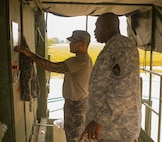 FORT HOOD, Texas – Sgt. 1st Class Julian Crawford of the 340th Quartermaster Company provides training to unit member Spc. Martin Benavides, on Aug. 16, 2016, his first day working with the laundry advance system.  (U.S. Army Reserve photo by Sgt. Michael Adetula/Released)
