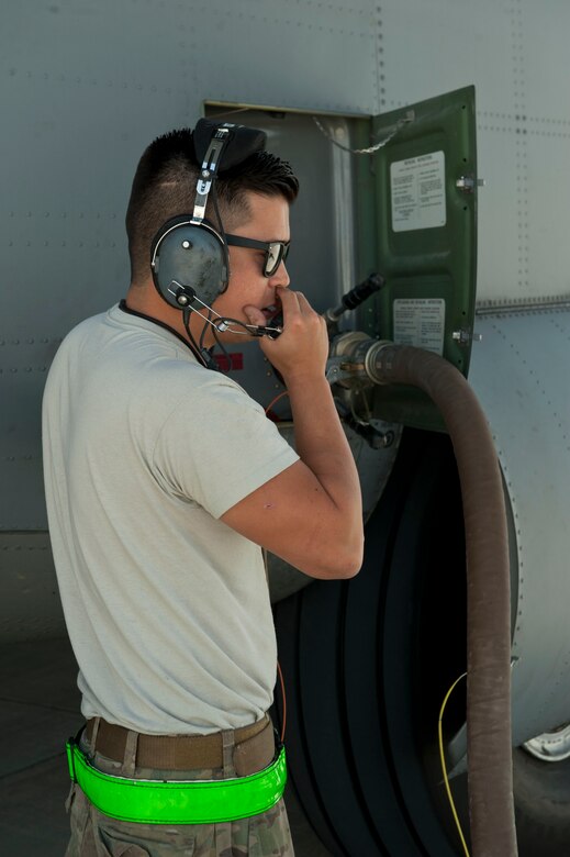Staff Sgt. Patrick Brennan, 455th Expeditionary Aircraft Maintenance Squadron crew chief, communicates with pilots as fuel is being offloaded from a C-130J Super Hercules, Camp Dwyer, Afghanistan,  Aug. 19, 2016. Brennan monitored the aircraft to ensure the fuel was safely being offloaded to storage tanks. (U.S. Air Force photo by Capt. Korey Fratini)