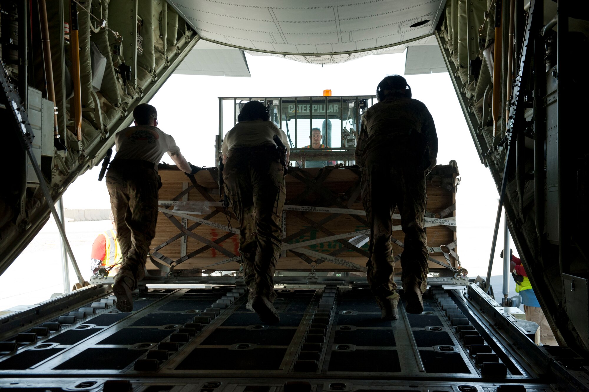 Loadmasters from the 774th Expeditionary Airlift Squadron offload a pallet of cargo onto a forklift at Camp Dywer, Afghanistan, Aug. 19, 2016. The C-130J Super Hercules is one of the primary aircraft used to deliver cargo and other
assets from the aerial port at Bagram Airfield, Afghanistan to other bases throughout the country. (U.S. Air Force photo by Capt. Korey Fratini)
