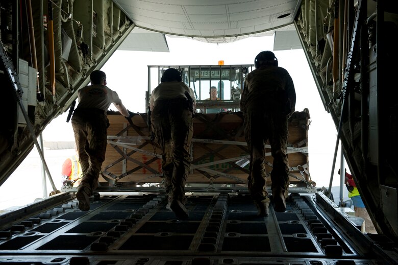 Loadmasters from the 774th Expeditionary Airlift Squadron offload a pallet of cargo onto a forklift at Camp Dywer, Afghanistan, Aug. 19, 2016. The C-130J Super Hercules is one of the primary aircraft used to deliver cargo and other
assets from the aerial port at Bagram Airfield, Afghanistan to other bases throughout the country. (U.S. Air Force photo by Capt. Korey Fratini)