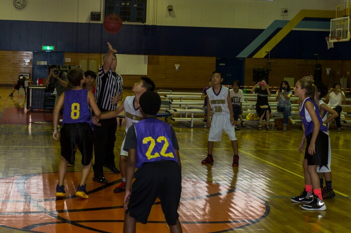 Athletes from Mainland Sports Association-Iwakuni and Iwakuni City start a game of basketball during a tournament held for station residents and Japanese nationals at Marine Corps Air Station Iwakuni, Japan, Aug. 21, 2016. Forty-four athletes from Iwakuni, Hirata, Ohno, Otake and MSA-Iwakuni took to the courts to compete against each other in a series of basketball games. Established in 2009 as a nonprofit organization and formerly known as the Mainland Basketball Association, MSA conducts off-base tournaments with the Japanese teams throughout the summer. (U.S. Marine Corps photo by Lance Cpl. Aaron Henson)