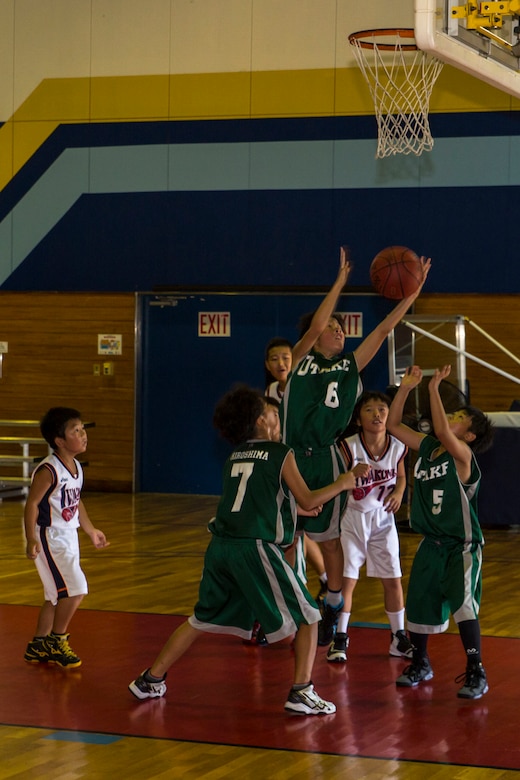 Japanese athletes from Otake and Iwakuni City play basketball during a basketball tournament held for station residents and Japanese nationals at Marine Corps Air Station Iwakuni, Japan, Aug. 21, 2016. Forty-four athletes from Iwakuni, Hirata, Ohno, Otake and Mainland Sports Association-Iwakuni took to the courts to compete against each other in a series of basketball games. The association assists young athletes in building character by using basketball to promote academic interest, athletic skills and aims to support and empower athletes using experienced coaches to help develop character, teamwork and leadership traits. (U.S. Marine Corps photo by Lance Cpl. Aaron Henson)