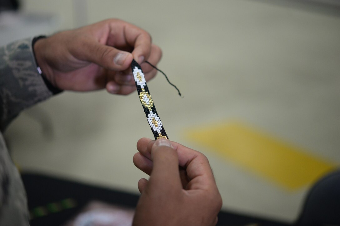 An Airman examines a Native American bracelet at Heritage Day at Royal Air Force Lakenheath, England, Aug. 19, 2016. Heritage Day allowed Airmen to celebrate the diversity of the Liberty Wing. (U.S. Air Force photo/Airman 1st Class Eli Chevalier) 