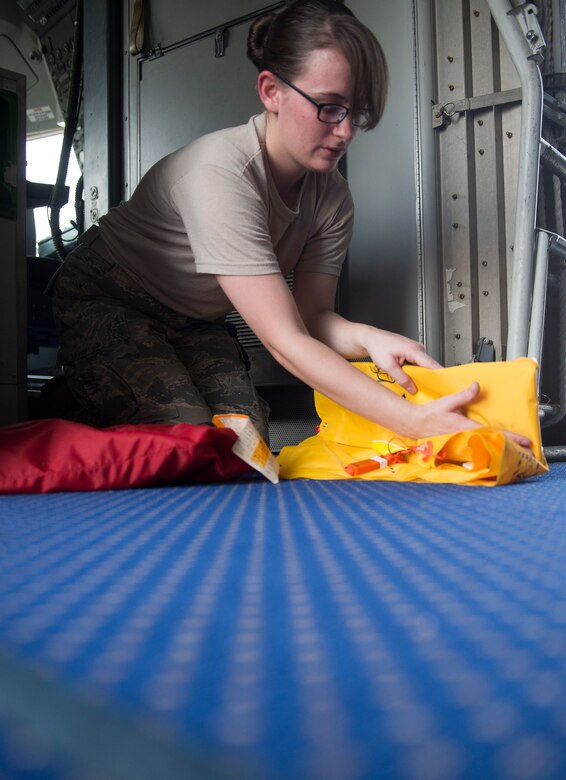 An aircrew flight equipment Airman from the 380th Expeditionary Operations Support Squadron inspects a flotation device on a KC-10 Extender at an undisclosed location in Southwest Asia Aug. 11, 2016. AFE Airmen maintain the aircraft components that may save the life of the aircrew in an emergency situation. (U.S. Air Force photo by Tech. Sgt. Chad Warren)