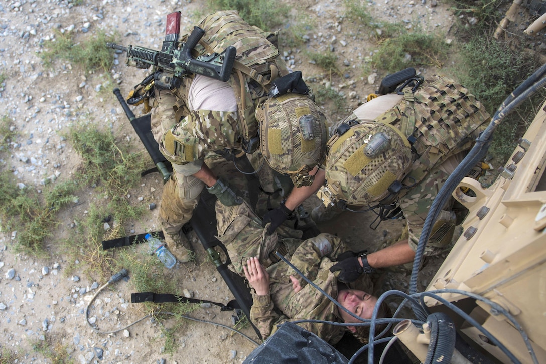 Air Force pararescuemen pull Air Force Staff Sgt. Rebecca Devoy from underneath a mine-resistant, ambush-protected vehicle during a joint mass casualty and extraction exercise at Bagram Airfield, Afghanistan, Aug. 18, 2016. Devoy is a paralegal specialist assigned to the 455th Expeditionary Maintenance Squadron. Air Force photo by Senior Airman Justyn M. Freeman