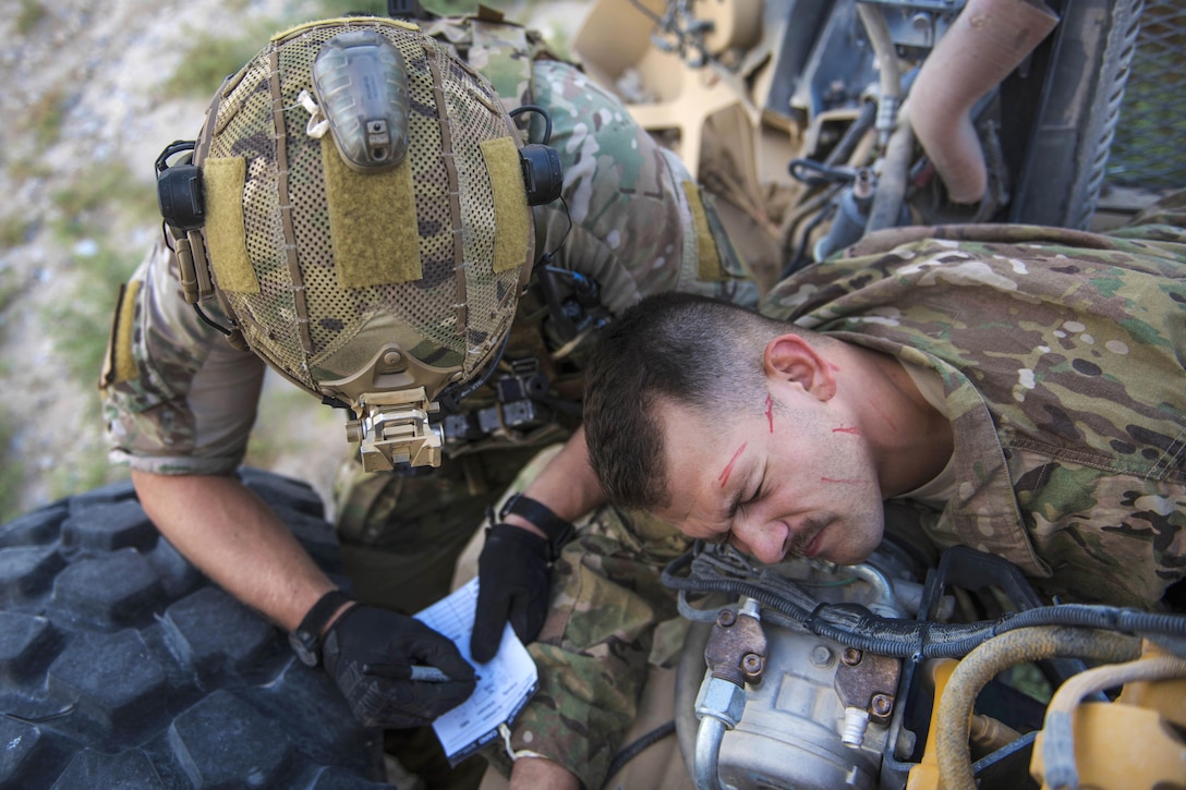 Air Force Senior Airman Austin Henson, left, provides aid to Senior Airman Russell Prisinki during a joint mass casualty and extraction exercise at Bagram Airfield, Afghanistan, Aug. 18, 2016. Henson is a pararescueman assigned to the 83rd Expeditionary Rescue Squadron. Prisinki is a Squadron traffic management journeyman assigned to the 455th Expeditionary Maintenance Squadron. Air Force photo by Senior Airman Justyn M. Freeman