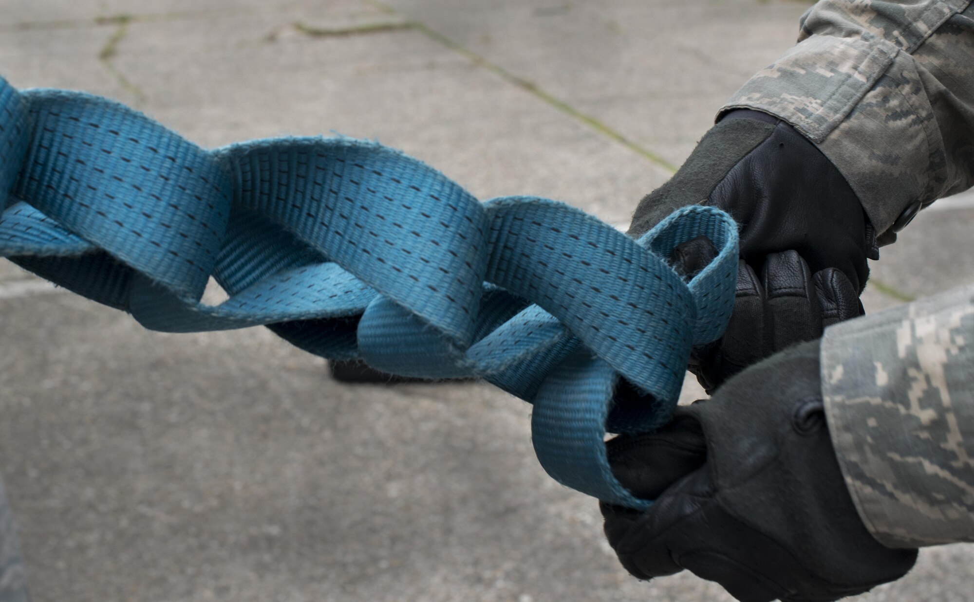 Airman 1st Class Brody Ellyson, 86th Vehicle Readiness Squadron vehicle operator, ties a loading strap using a daisy-chain technique Aug. 19, 2016 at Ramstein Air Base, Germany. Once the cargo is ready to be unloaded, the daisy-chain technique enables the strap to be undone with one pull. (U.S. Air Force photo/Senior Airman Tryphena Mayhugh)