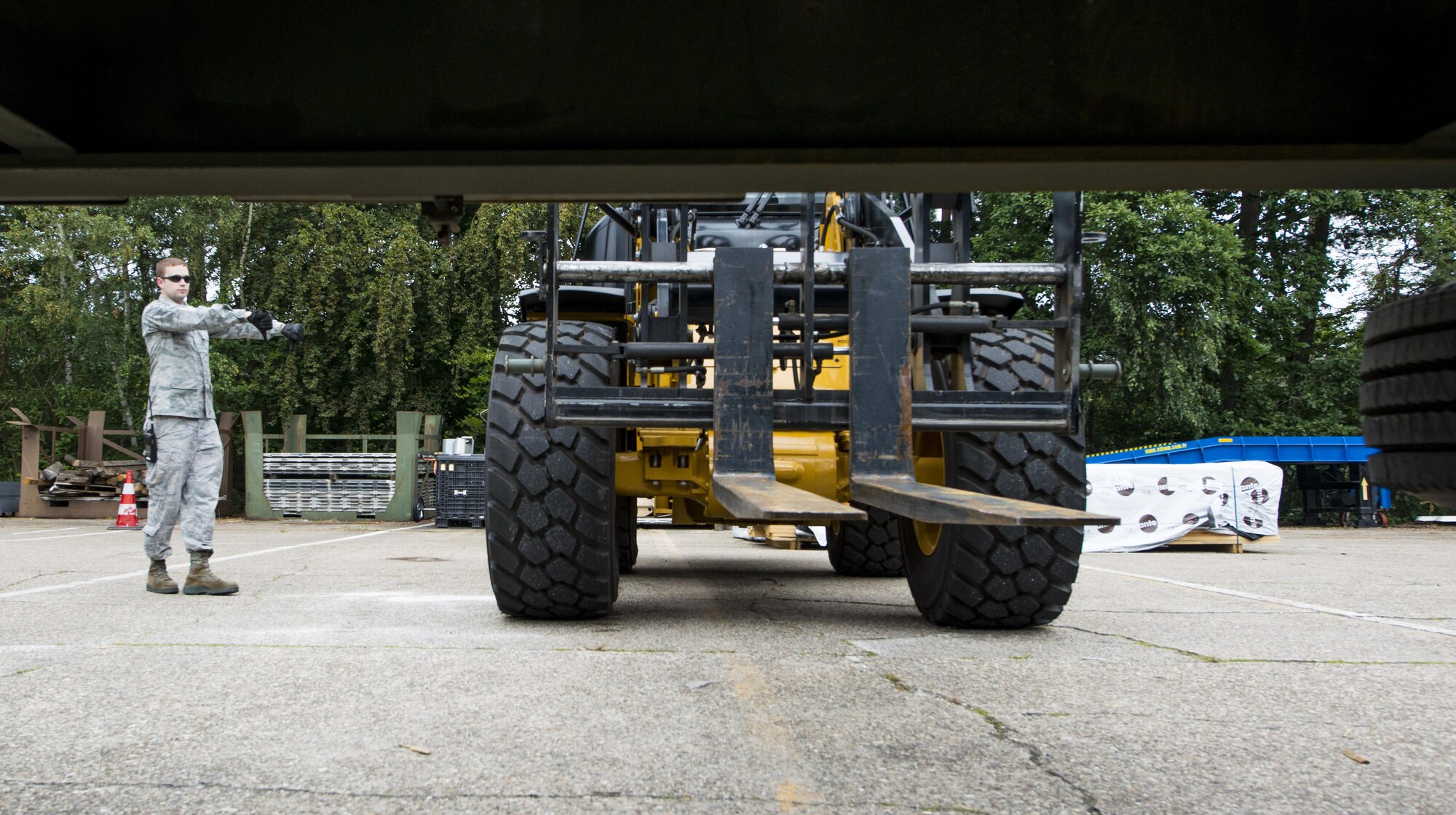 Senior Airman Joseph Clayson, 86th Vehicle Readiness Squadron vehicle operator, directs a forklift Aug. 19, 2016 at Ramstein Air Base, Germany. It’s the responsibility of vehicle operators to transport people, supplies, munitions and outsized expeditionary forces. (U.S. Air Force photo/Senior Airman Tryphena Mayhugh)