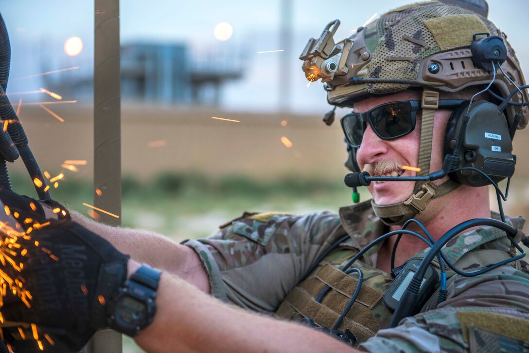 Air Force Senior Airman Kyle Green cuts the hinges on a mine-resistant, ambush-protected vehicle door during a mass casualty and extraction exercise at Bagram Airfield, Afghanistan, Aug. 18, 2016. Green is a pararescueman assigned to the 83rd Expeditionary Rescue Squadron. Air Force photo by Senior Airman Justyn M. Freeman