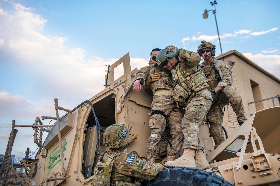 Air Force pararescuemen assist Air Force Senior Airman Joshua Calara, center left, out of a mine-resistant, ambush-protected vehicle turret during a joint mass casualty and extraction exercise at Bagram Airfield, Afghanistan, Aug. 18, 2016. Calara is an armament systems technician assigned to the 455th Expeditionary Maintenance Squadron. Air Force photo by Senior Airman Justyn M. Freeman