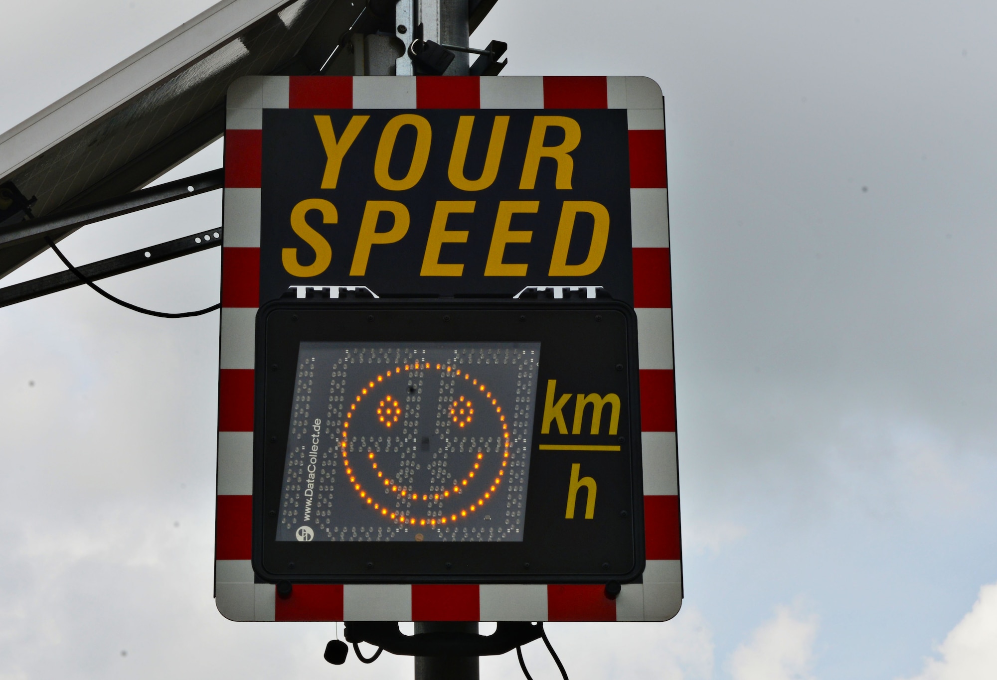 A speed limit sign displays a happy face when motorists adhere to the speed limit at Ramstein Air Base, Germany. The 86th Airlift Wing Safety office advises motorists to exercise caution in school zones to avoid potential mishaps. (U.S. Air Force photo Airman 1st Class Joshua Magbanua)