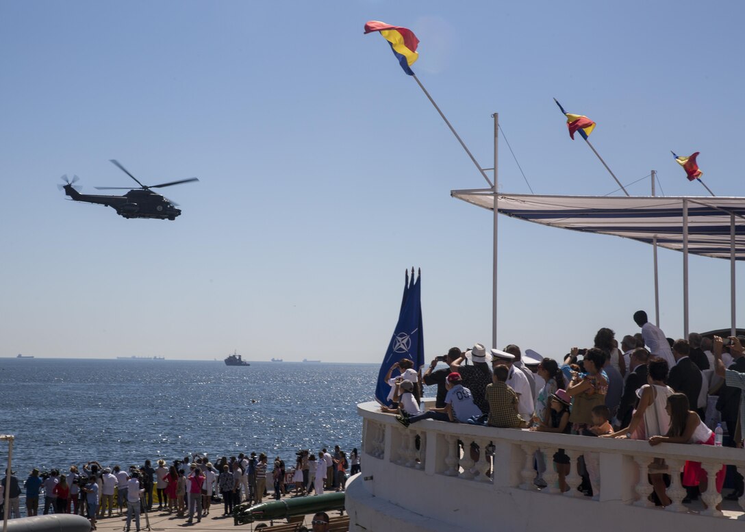 A Romanian helicopter delights a crowd of spectators during the 114th annual Navy Day celebration at the Port of Constanţa, Romania, Aug. 15, 2016. U.S. Sailors and Marines supporting the Black Sea Rotational Force 16.2 helped pay tribute to the prestigious history of the Romanian navy and highlighted the military’s movement toward new developments and modernizations. Black Sea Rotational Force is an annual multilateral security cooperation activity between the U.S. Marine Corps and partner nations in the Black Sea, Balkan and Caucasus regions designed to enhance participants’ collective professional military capacity, promote regional stability and build enduring relationships with partner nations. (U.S. Marine Corps photo by Sgt. Michelle Reif)