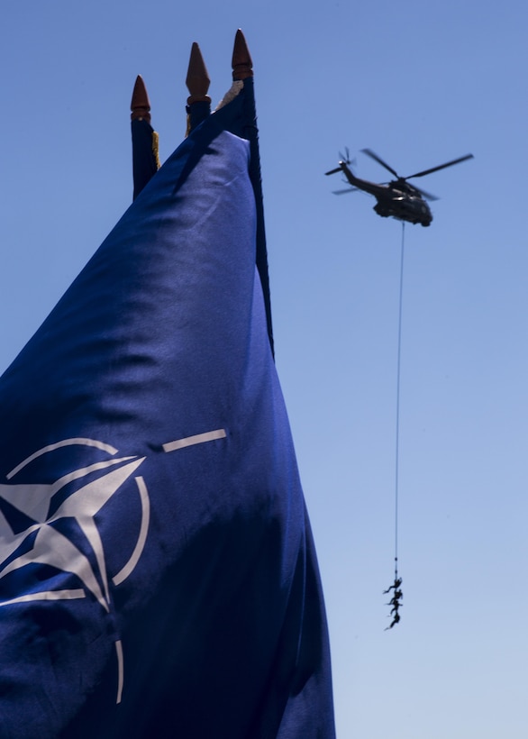 Three Romanian sailors hang suspended from a helicopter while a delighted crowd spectates during the 114th annual Navy Day celebration at the Port of Constanţa, Romania, Aug. 15, 2016. U.S. Sailors and Marines supporting the Black Sea Rotational Force 16.2 helped pay tribute to the prestigious history of the Romanian navy and highlighted the military’s movement toward new developments and modernizations. Black Sea Rotational Force is an annual multilateral security cooperation activity between the U.S. Marine Corps and partner nations in the Black Sea, Balkan and Caucasus regions designed to enhance participants’ collective professional military capacity, promote regional stability and build enduring relationships with partner nations. (U.S. Marine Corps photo by Sgt. Michelle Reif)