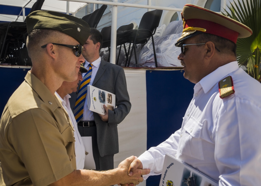 U.S. Marine Corps Lt. Col. Paul C. Teachey, the commanding officer of the Black Sea Rotational Force, shakes hands with Romanian Brigadier General Adrian Soci during the 114th annual Navy Day celebration at the Port of Constanţa, Romania, Aug. 15, 2016. Representatives from BSRF 16.2 attended the event as a sign of partnership before the first major exercise which will build security cooperation between nations in the Black Sea region. Black Sea Rotational Force is an annual multilateral security cooperation activity between the U.S. Marine Corps and partner nations in the Black Sea, Balkan and Caucasus regions designed to enhance participants’ collective professional military capacity, promote regional stability and build enduring relationships with partner nations. (U.S. Marine Corps photo by Sgt. Michelle Reif)