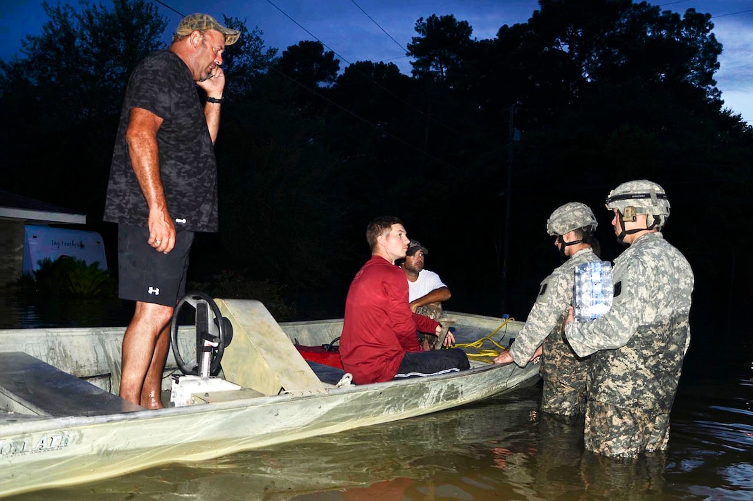 Soldiers check on residents in a boat in Crowley, La., Aug. 17, 2016. Heavy rains caused severe flooding in the area. Army National Guard photo by Sgt. Noshoba Davis