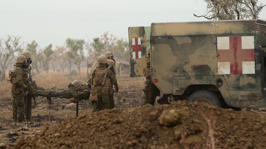 Marines and sailors with 1st Battalion, 1st Marine Regiment, evacuate a simulated casualty during a live fire range August 18, 2016, at Bradshaw Field Training Area, Northern Territory, Australia. The range was the final training evolution of Exercise Koolendong 16, a trilateral exercise between the U.S. Marine Corps, Australian Defence Force and French Armed Forces New Caledonia. Marines held a defensive position while engaging targets and working through the CS gas, which simulated a chemical attack.