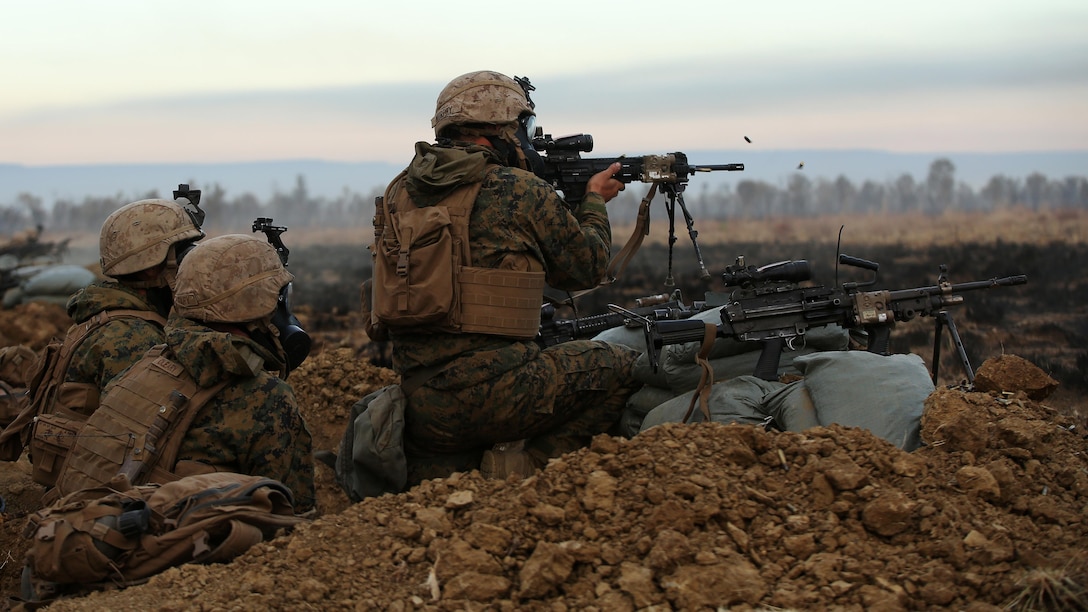 Marines with Company C, 1st Battalion, 1st Marine Regiment, fire down range during a CS gas attack during a live fire range August 18, 2016, at Bradshaw Field Training Area, Northern Territory, Australia. The range was the final training evolution of Exercise Koolendong 16, a trilateral exercise between the U.S. Marine Corps, Australian Defence Force and French Armed Forces New Caledonia. Marines held a defensive position while engaging targets and working through the CS gas, which simulated a chemical attack.