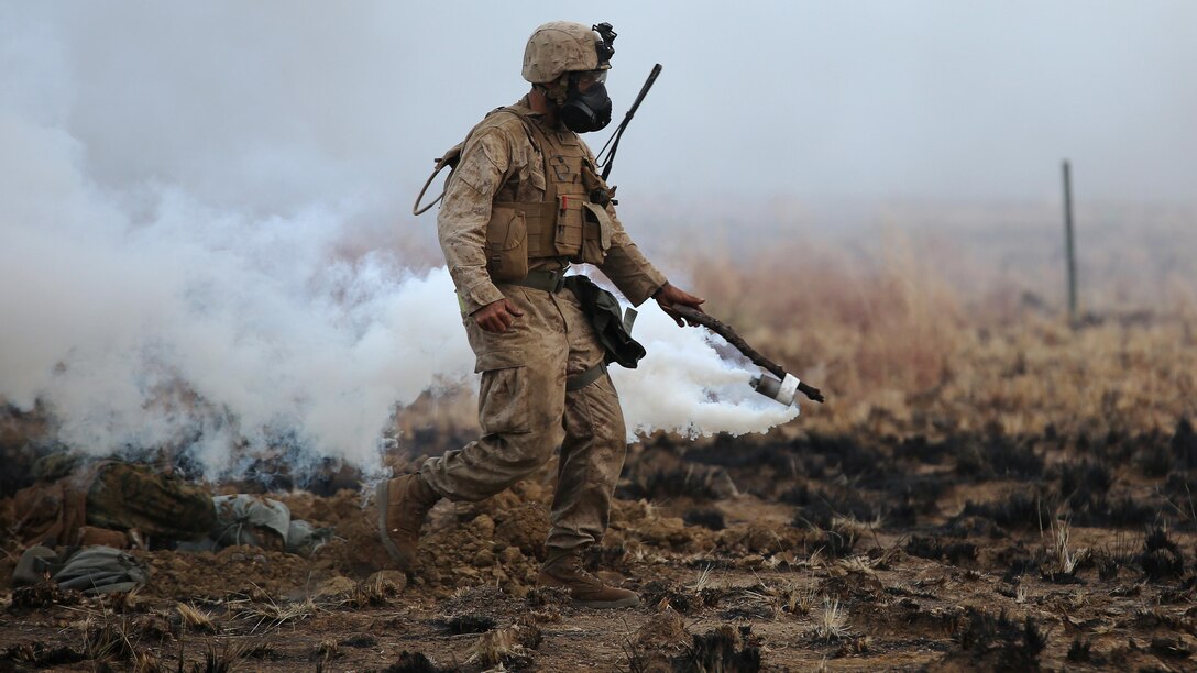 A range safety officer spreads CS gas during a live fire range August 18, 2016, to simulate a chemical attack at Bradshaw Field Training Area, Northern Territory, Australia. The range was the final training evolution of Exercise Koolendong 16, a trilateral exercise between the U.S. Marine Corps, Australian Defence Force and French Armed Forces New Caledonia. Marines held a defensive position while engaging targets and working through the CS gas.