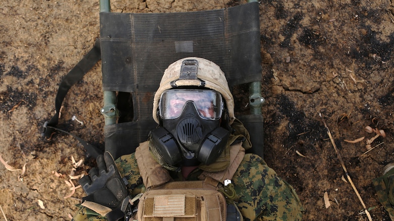 A simulated casualty lays on a litter before a decontamination process after a CS gas attack August 18, 2016, at Bradshaw Field Training Area, Northern Territory, Australia. The Marine took part in the final  live fire range of Exercise Koolendong 16, a trilateral exercise between the U.S. Marine Corps, Australian Defence Force and French Armed Forces New Caledonia. Marines held a defensive position while engaging targets and working through the CS gas, which simulated a chemical attack.